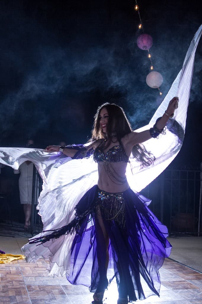 Belly Dancer Carrara Nour performs with Isis wings at an Armenian and Puerto Rican wedding at Estate of Johns Lake in Oakland, Florida. Photo: Scott Trippler Studios