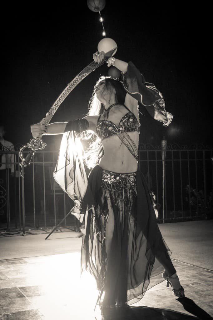 Belly Dancer Carrara Nour performs with a sword at an Armenian and Puerto Rican wedding at Estate of Johns Lake in Oakland, Florida. Photo: Scott Trippler Studios