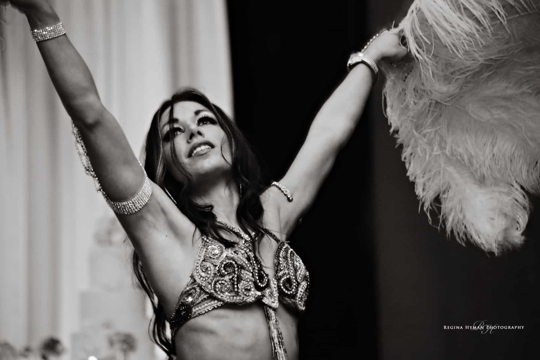 Belly Dancer Carrara Nour performs with feather fans at a wedding at the Ballroom at Church Street in Orlando