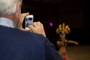 A guest takes a picture of Orlando belly dancer Carrara Nour