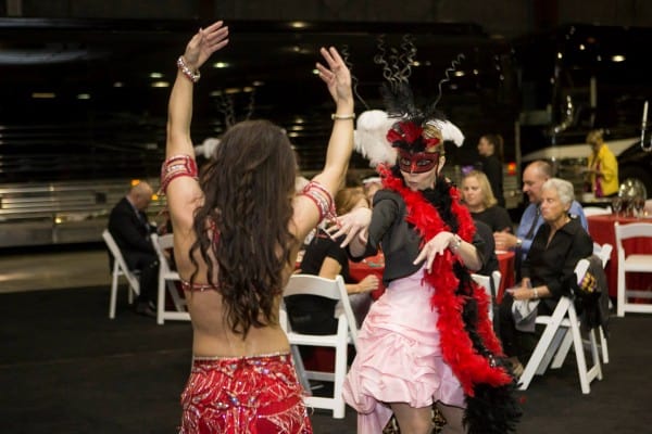 Carrara Nour, a belly dancer in Orlando, hams it up with a party guest