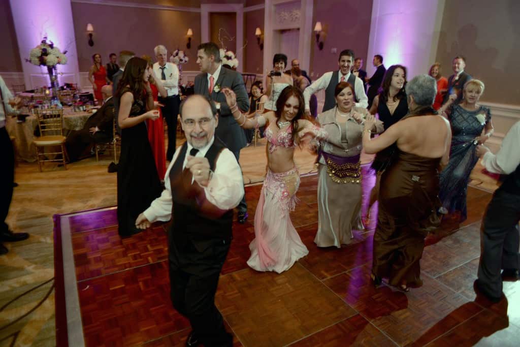 Belly dancer Carrara Nour of Orlando, FL gets the crowd to dance at a Turkish-American wedding