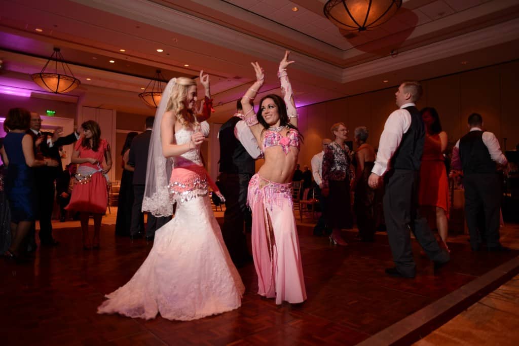 Carrara Nour, a belly dancer in Orlando, dances with the bride at a wedding at JW Marriott Grande Lakes, Orlando, FL