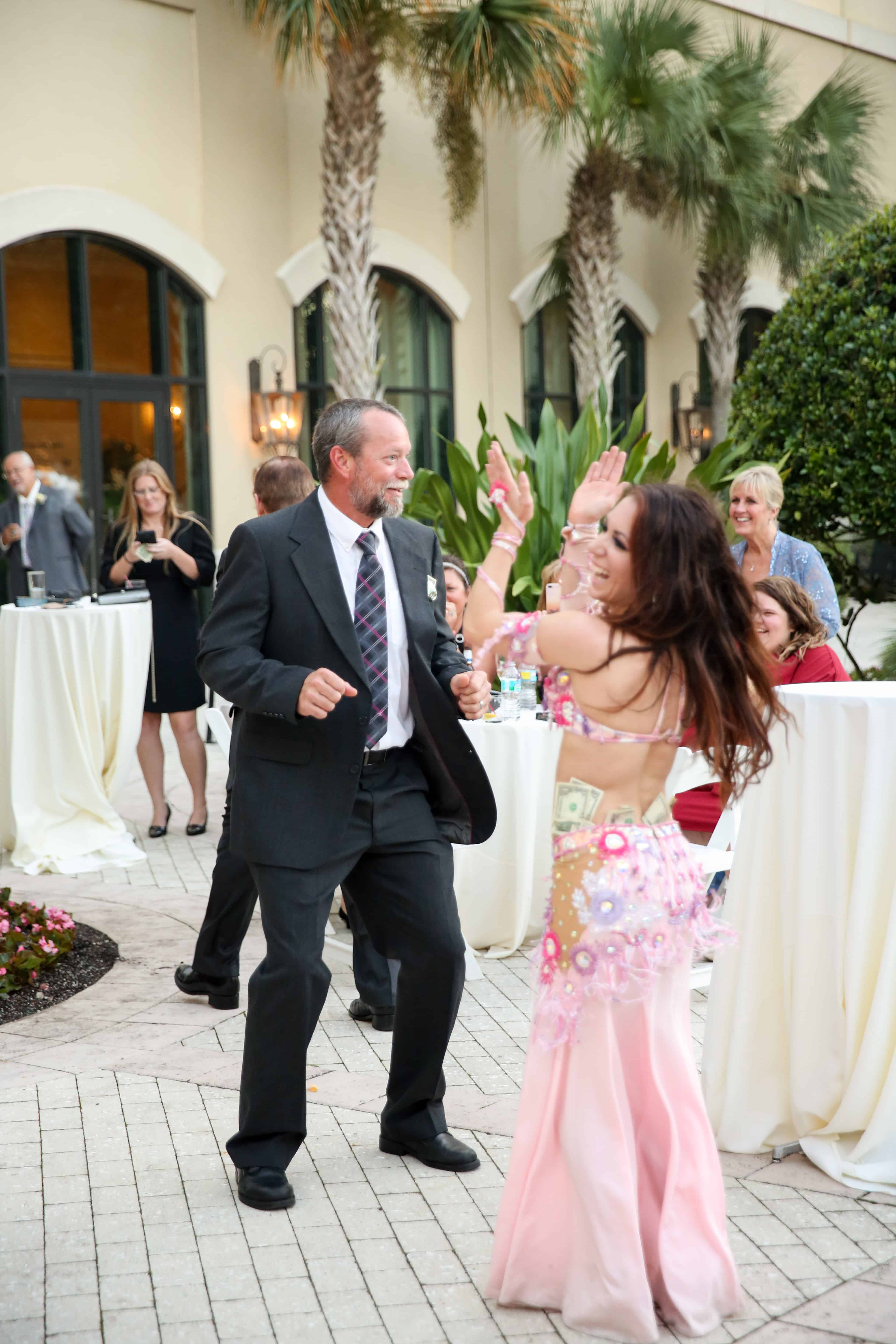 Carrara performs belly dance during the cocktail hour at an LGBT wedding at Omni Championsgate. Photo by LiveHappy Studio
