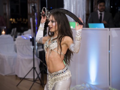 Carrara Nour (professional belly dancer for hire in Orlando) performs belly dance with a sword at an Indian anniversary party